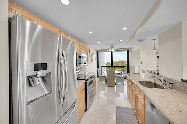 kitchen with recessed lighting, visible vents, light brown cabinetry, appliances with stainless steel finishes, and a sink