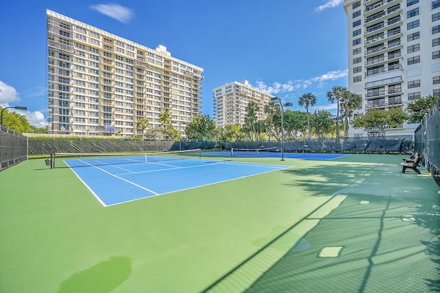 view of tennis court featuring fence