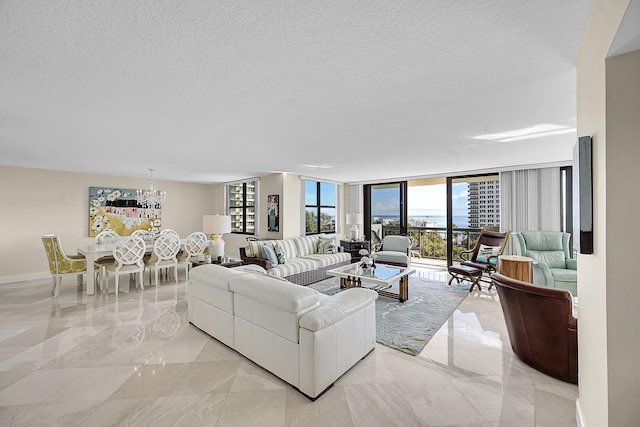 living area featuring expansive windows, marble finish floor, a textured ceiling, and an inviting chandelier