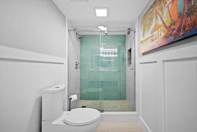 bathroom with toilet and a stall shower