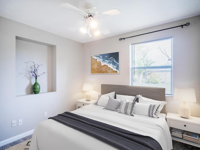 bedroom with a ceiling fan and baseboards