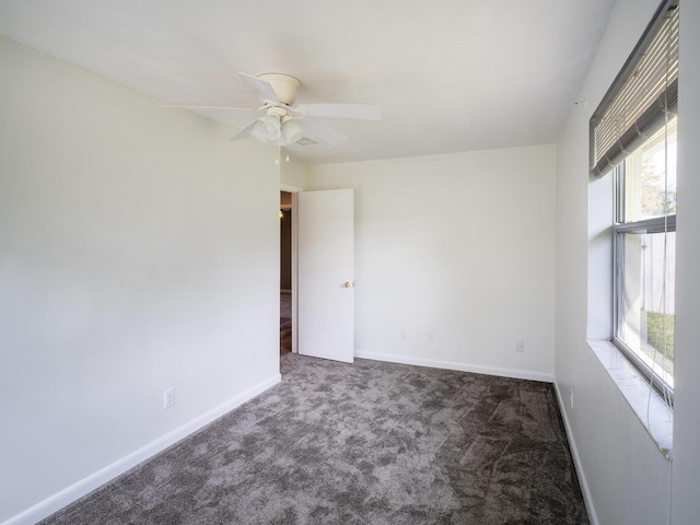 unfurnished room with carpet floors, baseboards, and a ceiling fan