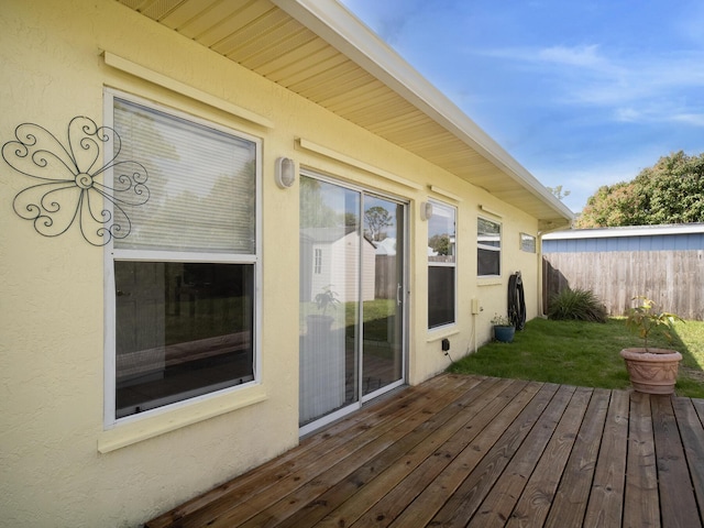 deck with fence and a lawn