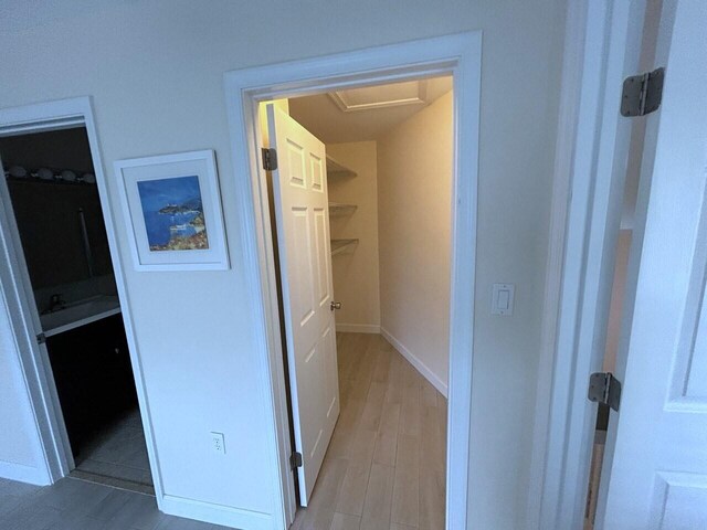 bedroom with visible vents, a ceiling fan, light wood-style flooring, and baseboards