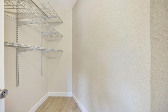 19203 Glenmoor Dr, West Palm Beach, FL 33409 - walk in closet featuring wood finished floors