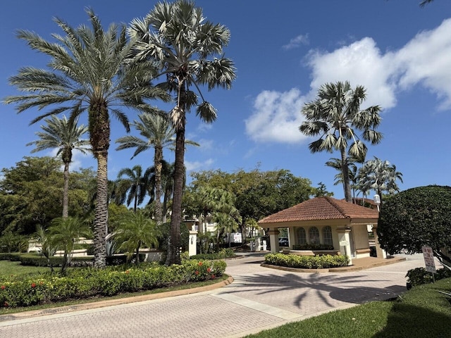 exterior space with a tile roof and stucco siding