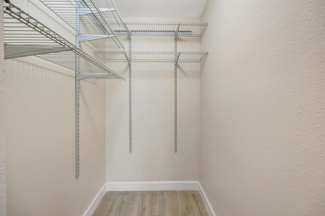 19203 Glenmoor Dr, West Palm Beach, FL 33409 - spacious closet featuring wood finished floors