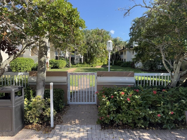 view of community with fence and a gate