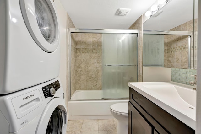 19203 Glenmoor Dr, West Palm Beach, FL 33409 - full bathroom with stacked washer / drying machine, vanity, enclosed tub / shower combo, and tile patterned flooring