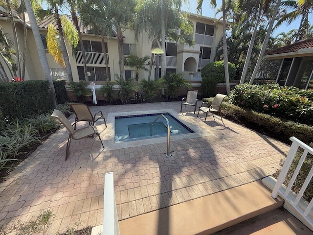 view of pool featuring a community hot tub and a patio area