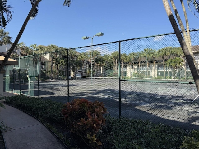 view of sport court featuring fence