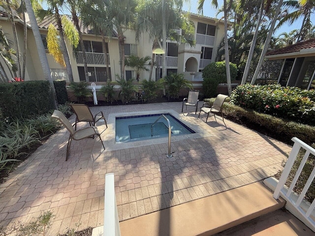 19203 Glenmoor Dr, West Palm Beach, FL 33409 - view of pool featuring a community hot tub and a patio