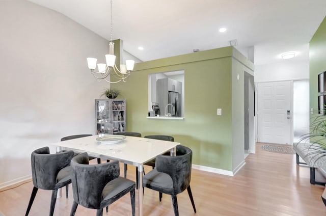 dining room featuring lofted ceiling, recessed lighting, a notable chandelier, baseboards, and light wood finished floors