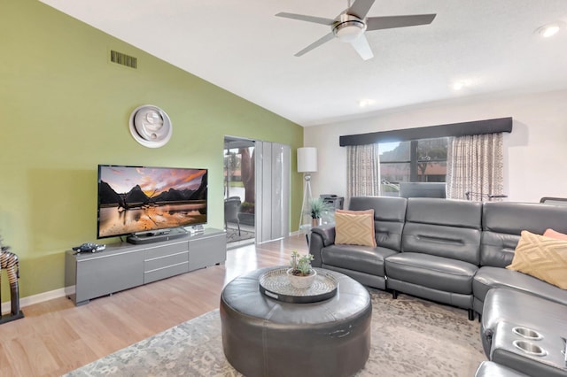 living area with wood finished floors, a ceiling fan, visible vents, vaulted ceiling, and baseboards