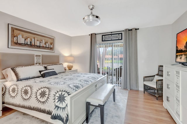 bedroom featuring access to outside and light wood-style flooring