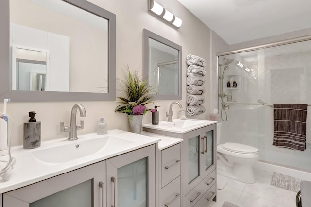 full bathroom featuring a stall shower, a sink, and toilet