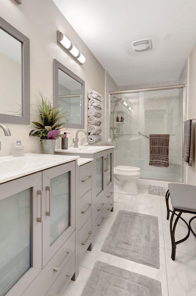 bathroom featuring a stall shower, visible vents, toilet, marble finish floor, and vanity