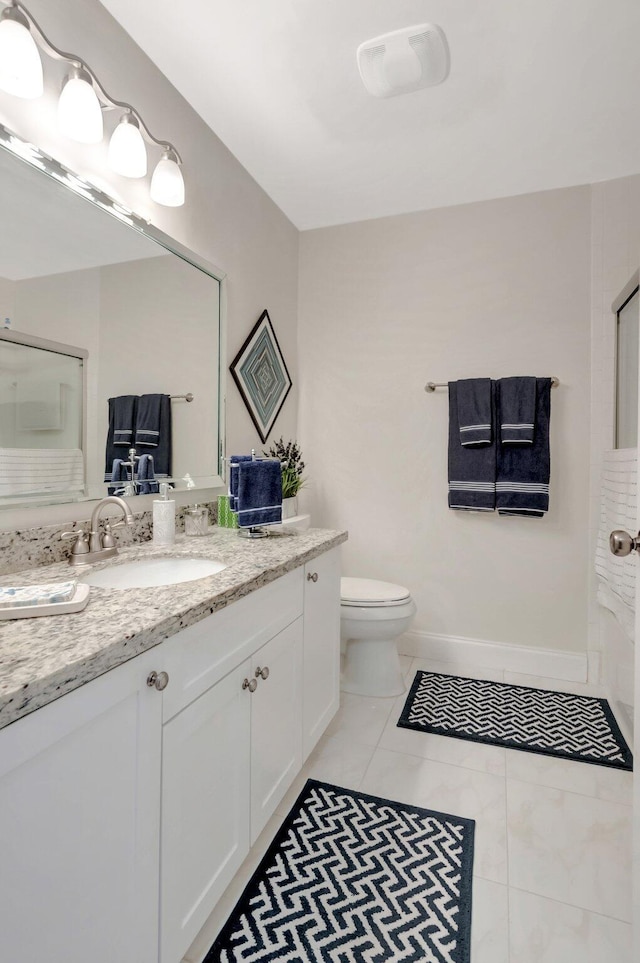 full bathroom with toilet, tile patterned flooring, baseboards, and vanity