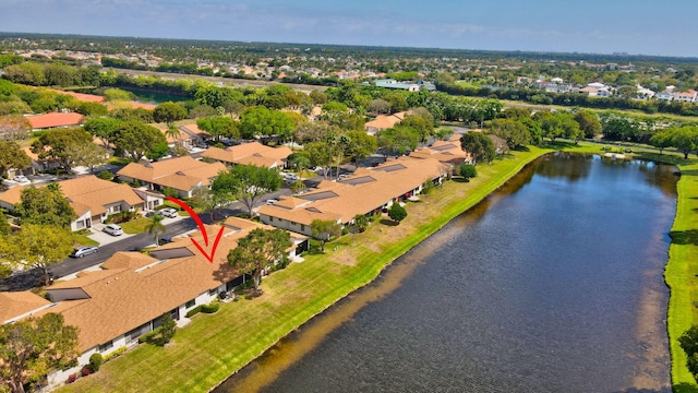 drone / aerial view featuring a residential view and a water view