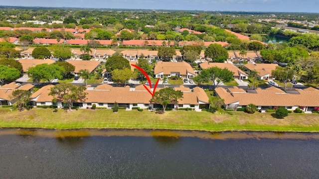 drone / aerial view featuring a residential view and a water view