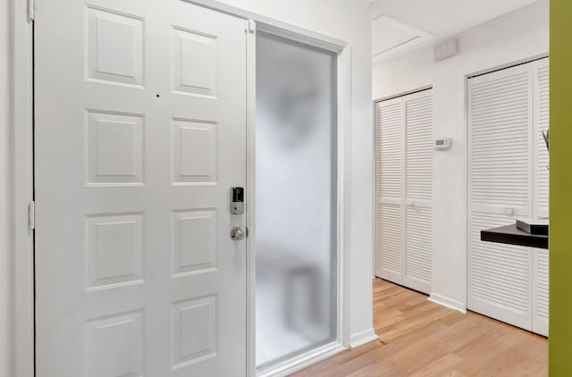 foyer featuring light wood-type flooring and baseboards