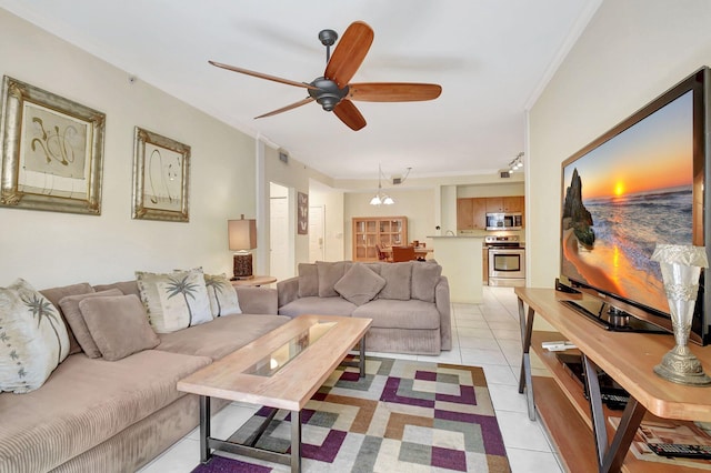 living room with light tile patterned floors, ornamental molding, and a ceiling fan