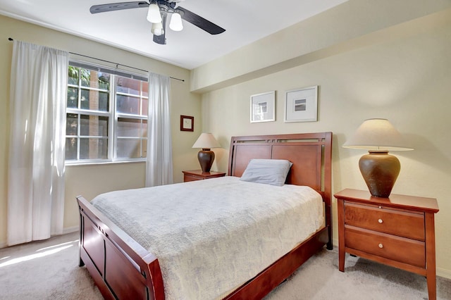 bedroom with ceiling fan, carpet flooring, and baseboards