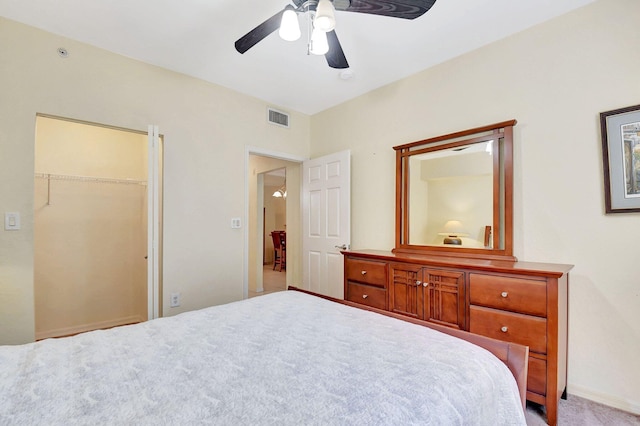 bedroom with a ceiling fan, baseboards, visible vents, and carpet flooring