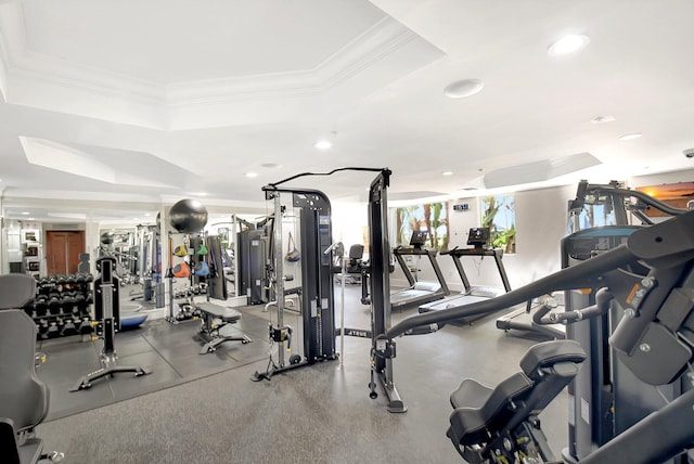 exercise room featuring ornamental molding, a tray ceiling, and recessed lighting