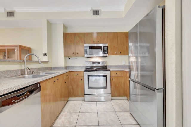 kitchen with light tile patterned floors, visible vents, stainless steel appliances, crown molding, and a sink