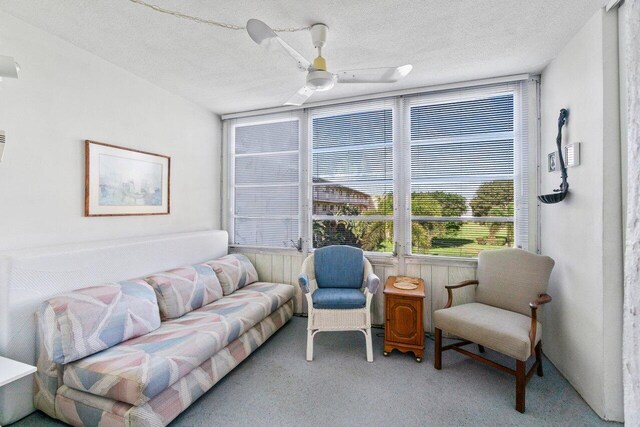 carpeted living room with visible vents and a textured ceiling