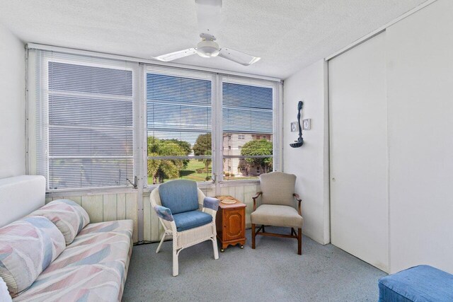 carpeted living room featuring a textured ceiling and visible vents