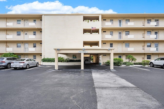 view of property featuring uncovered parking