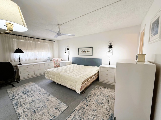 bedroom featuring ceiling fan and a textured ceiling