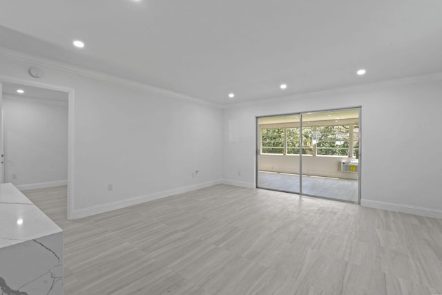 empty room featuring crown molding, recessed lighting, and baseboards
