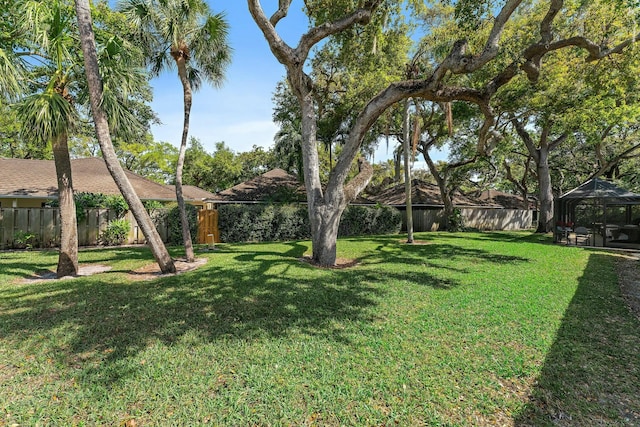 view of yard featuring a gazebo and a fenced backyard