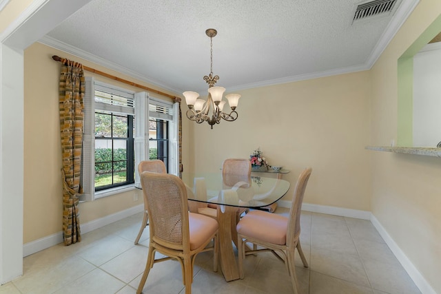 dining space featuring a textured ceiling, a notable chandelier, visible vents, and ornamental molding