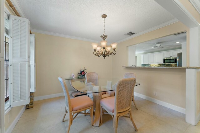 dining space featuring visible vents, baseboards, a textured ceiling, and ornamental molding