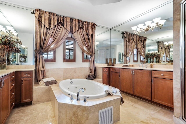 bathroom with visible vents, vanity, and a whirlpool tub