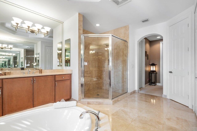 bathroom featuring a tub, a stall shower, visible vents, and vanity