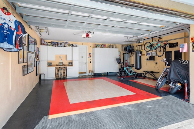 garage with gas water heater and a garage door opener