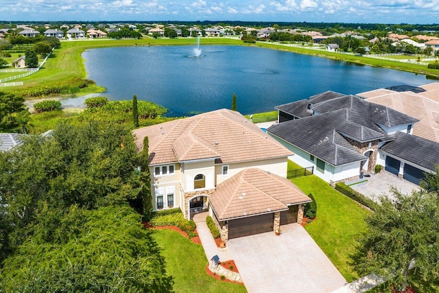 drone / aerial view featuring a water view and a residential view