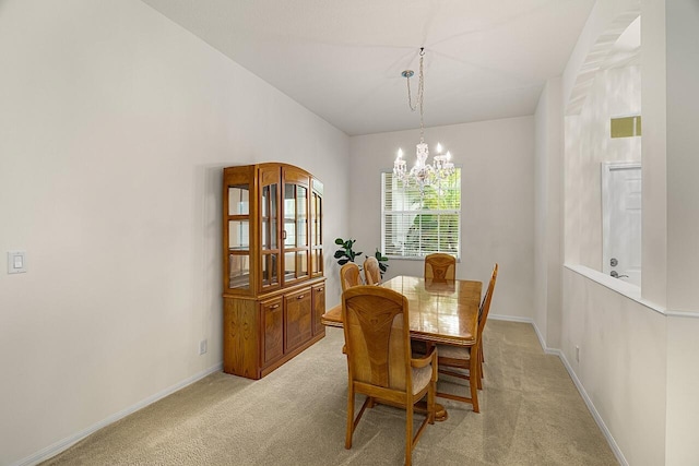 10617 Pine Cone Ln, Fort Pierce, FL 34945 - dining room featuring light carpet, baseboards, and a notable chandelier