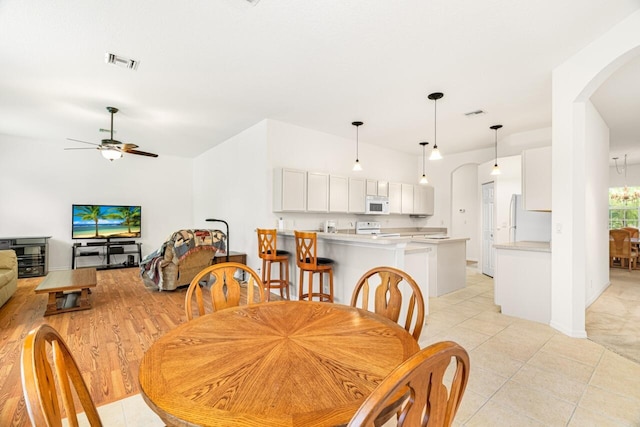 10617 Pine Cone Ln, Fort Pierce, FL 34945 - dining space featuring arched walkways, visible vents, ceiling fan, and light tile patterned floors