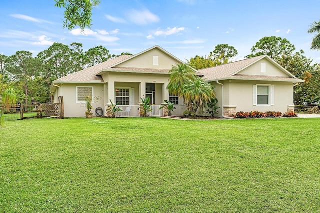 view of front of property featuring a porch, a front yard, fence, and stucco siding