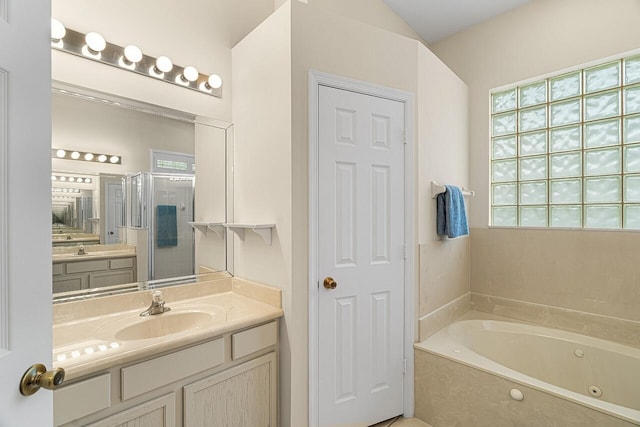 10617 Pine Cone Ln, Fort Pierce, FL 34945 - bathroom featuring a shower stall, a tub with jets, and vanity