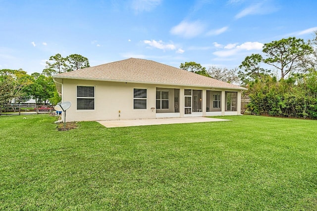 10617 Pine Cone Ln, Fort Pierce, FL 34945 - back of property featuring a yard, a patio, roof with shingles, and stucco siding