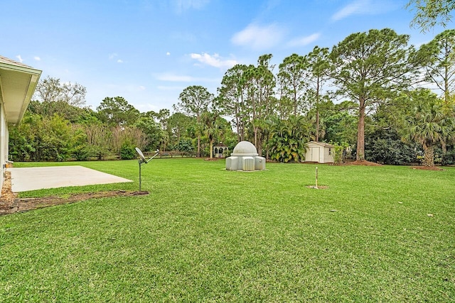 10617 Pine Cone Ln, Fort Pierce, FL 34945 - view of yard with a storage unit, a patio, and an outbuilding