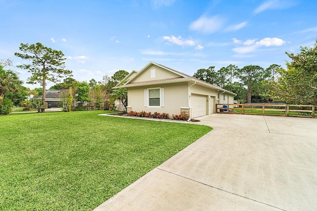 10617 Pine Cone Ln, Fort Pierce, FL 34945 - single story home featuring a garage, fence, driveway, stucco siding, and a front yard