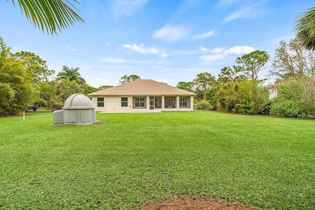 10617 Pine Cone Ln, Fort Pierce, FL 34945 - rear view of house with a lawn and stucco siding